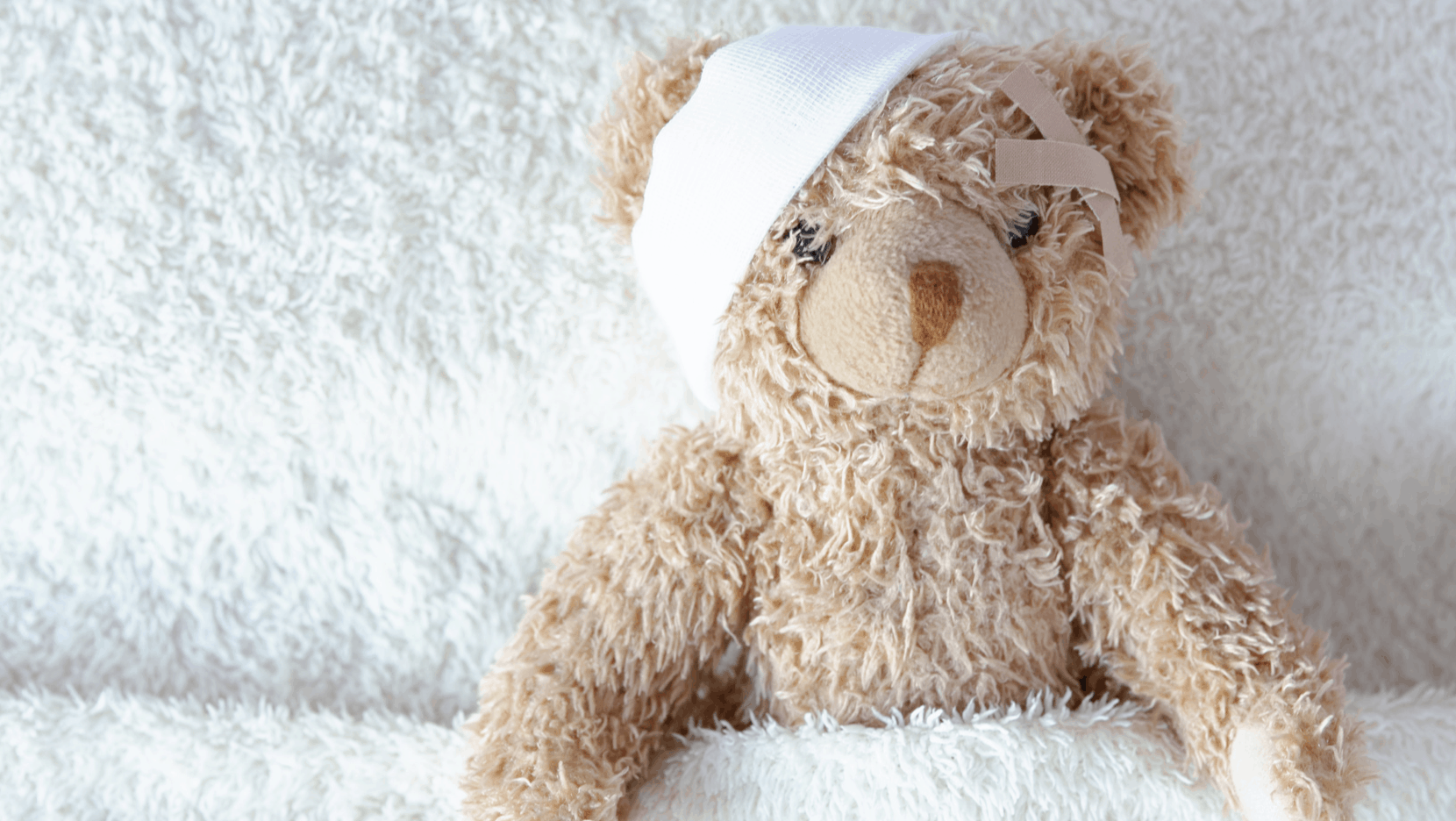 Teddybär, der einen Verband um sein rechtes Ohr trägt
